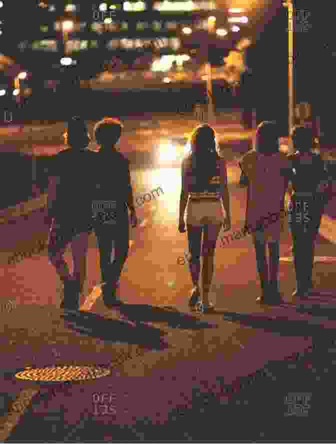 A Group Of Teenagers Walking Through A Dark Street At Night Adolescence And Night/L Adolescenza E La Notte